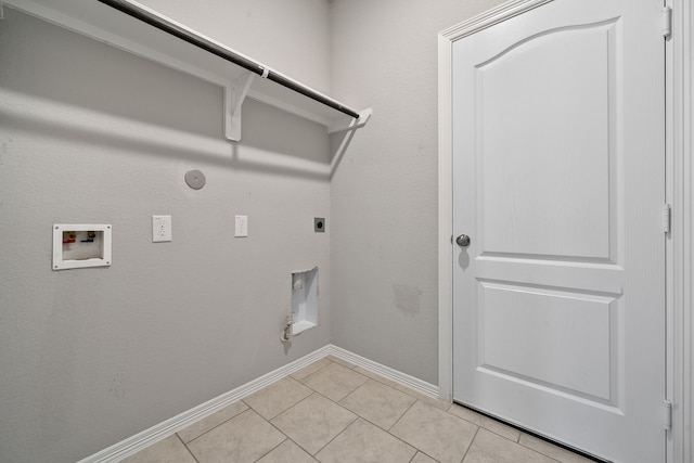 clothes washing area featuring hookup for an electric dryer, light tile patterned flooring, washer hookup, and gas dryer hookup