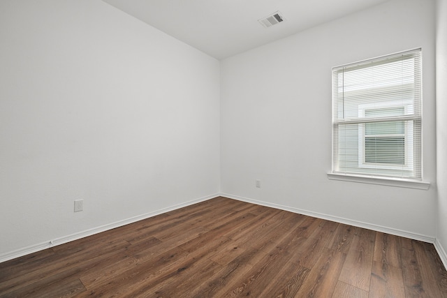 unfurnished room featuring dark hardwood / wood-style flooring