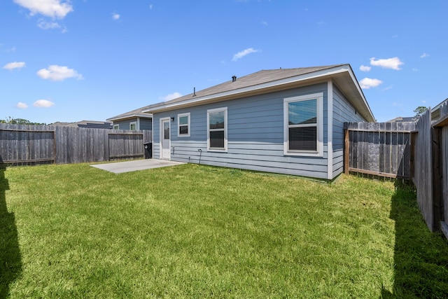 back of property with a patio and a yard