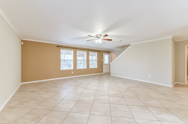 spare room featuring crown molding, light tile patterned flooring, and ceiling fan