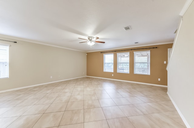 unfurnished room featuring ceiling fan, ornamental molding, light tile patterned floors, and plenty of natural light