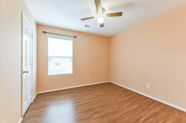 empty room with wood-type flooring and ceiling fan