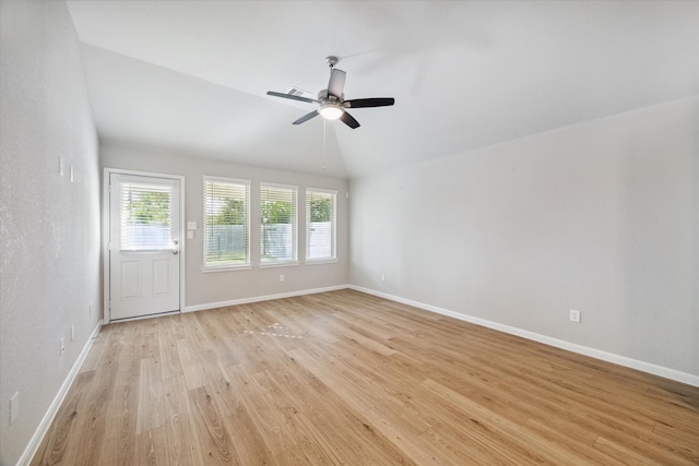 spare room featuring light hardwood / wood-style floors, ceiling fan, and vaulted ceiling