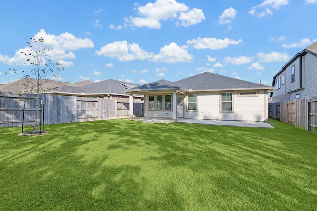 back of house with a patio and a lawn