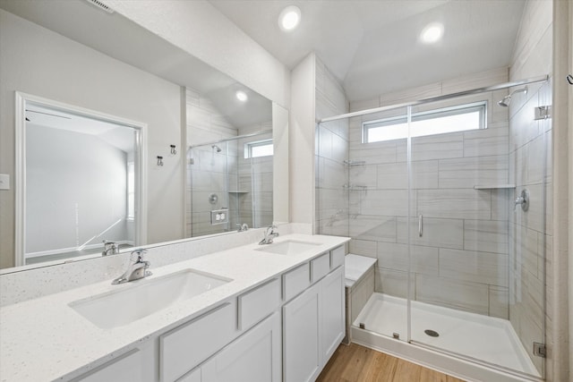 bathroom with vanity, an enclosed shower, hardwood / wood-style floors, and vaulted ceiling