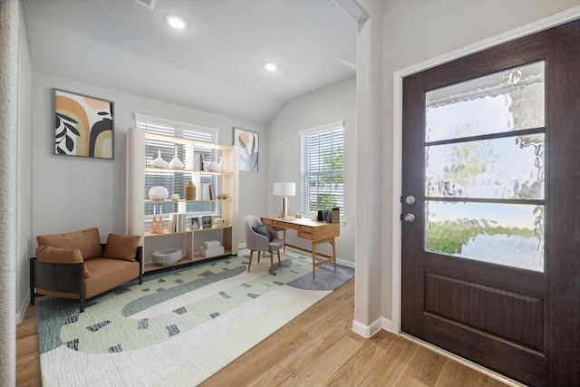 entrance foyer with light hardwood / wood-style flooring and vaulted ceiling