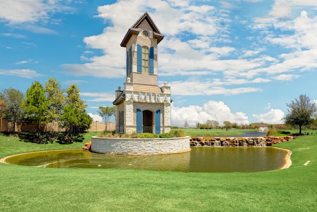 view of community featuring a water view and a lawn