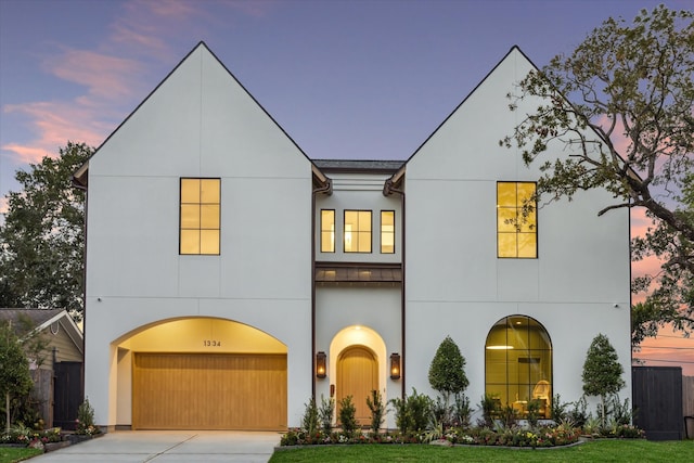 view of front of house featuring a garage and a yard