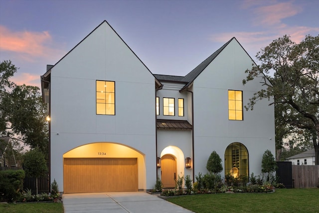 view of front of home with a lawn and a garage