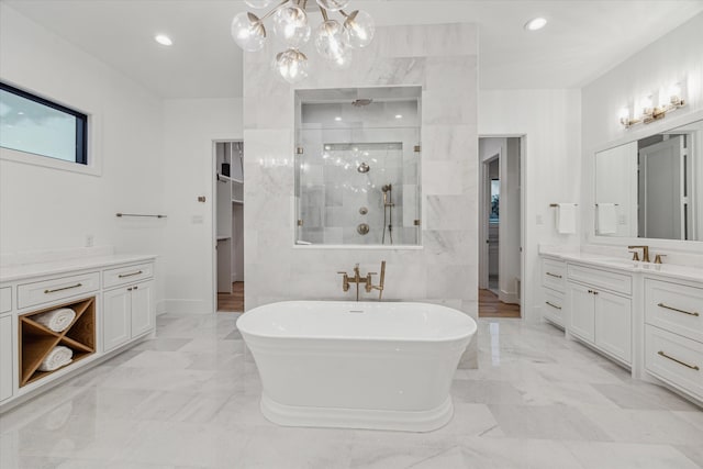 bathroom with vanity and shower with separate bathtub