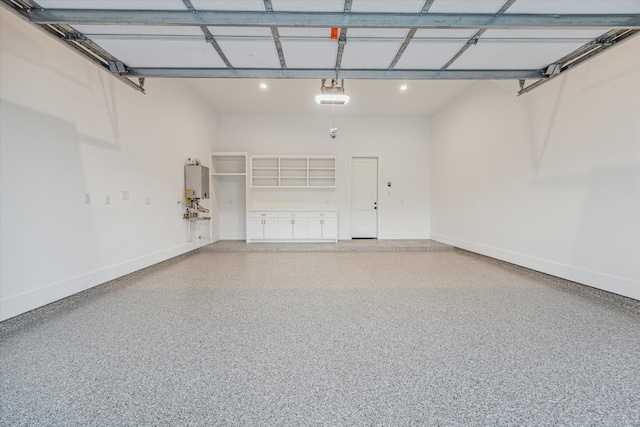 garage featuring water heater and a garage door opener