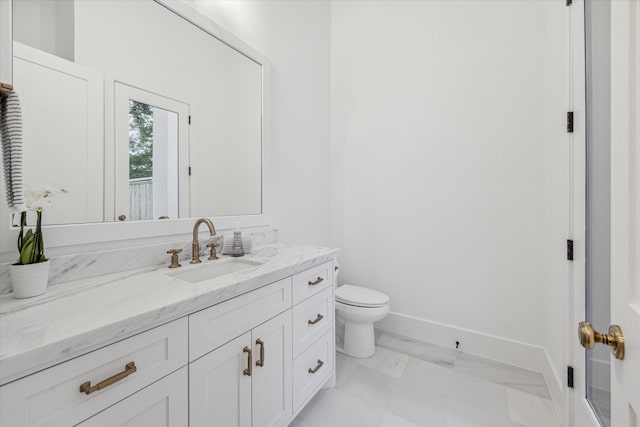 bathroom with tile patterned floors, vanity, and toilet