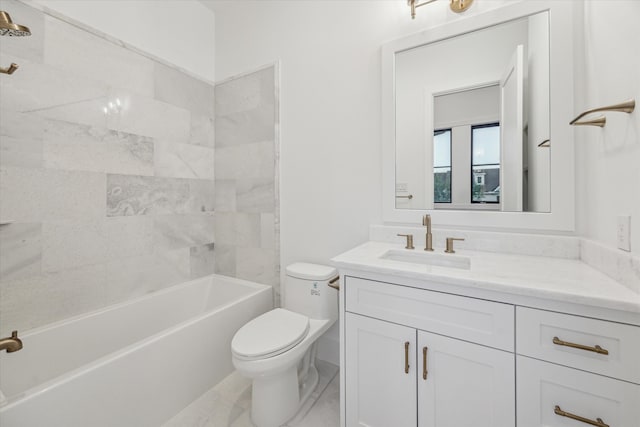 full bathroom with toilet, vanity, and tiled shower / bath