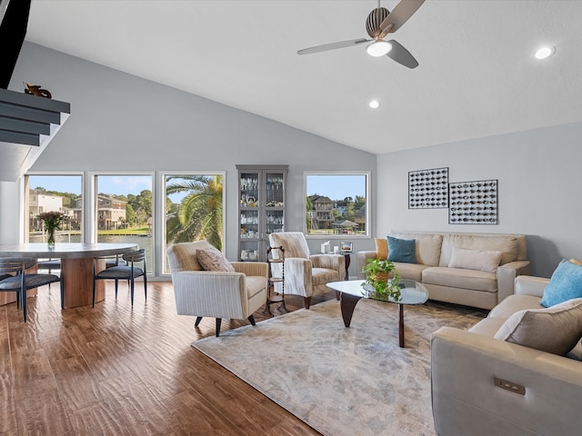 living room featuring high vaulted ceiling, a wealth of natural light, hardwood / wood-style flooring, and ceiling fan