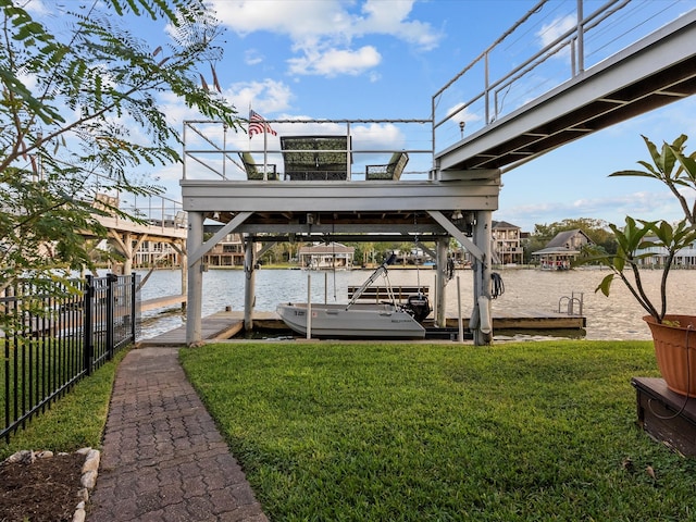 view of dock featuring a water view and a yard