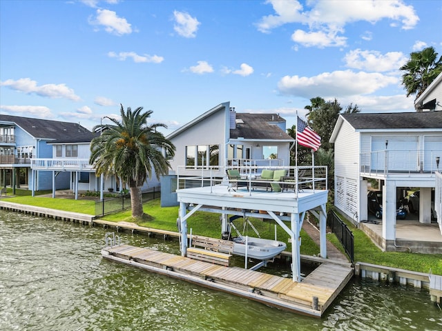 view of dock featuring a water view and a yard