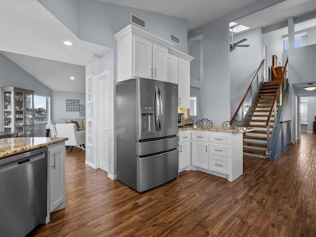 kitchen featuring white cabinets, dark hardwood / wood-style flooring, kitchen peninsula, and appliances with stainless steel finishes