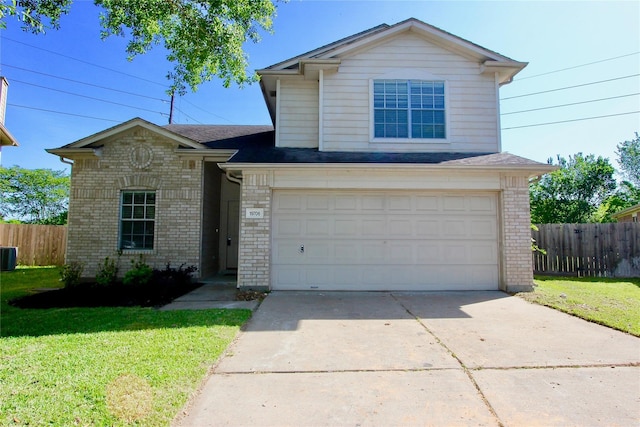 view of front of house featuring cooling unit, a front yard, and a garage