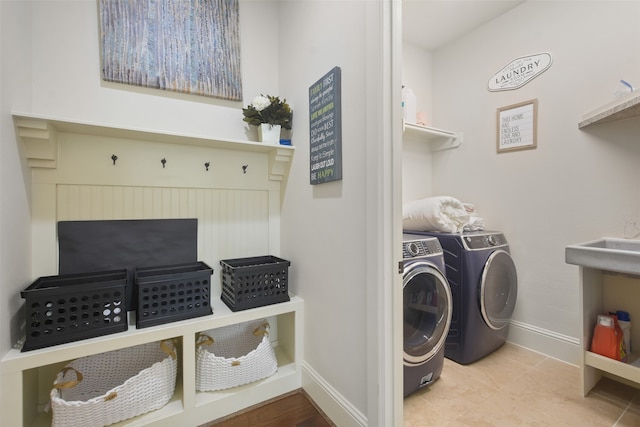 washroom featuring washing machine and clothes dryer and light tile patterned floors