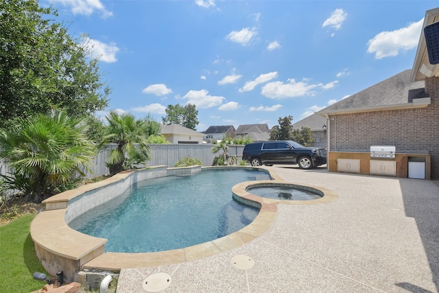 view of swimming pool featuring area for grilling and an in ground hot tub