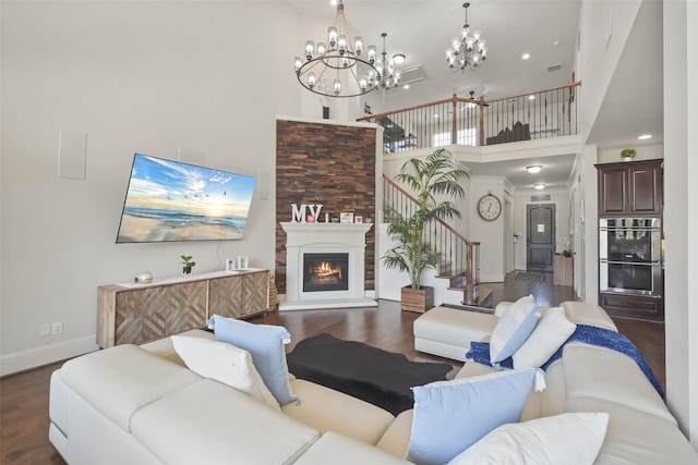 living room with a towering ceiling and dark hardwood / wood-style flooring