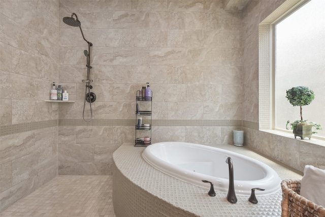 bathroom featuring a healthy amount of sunlight and shower with separate bathtub