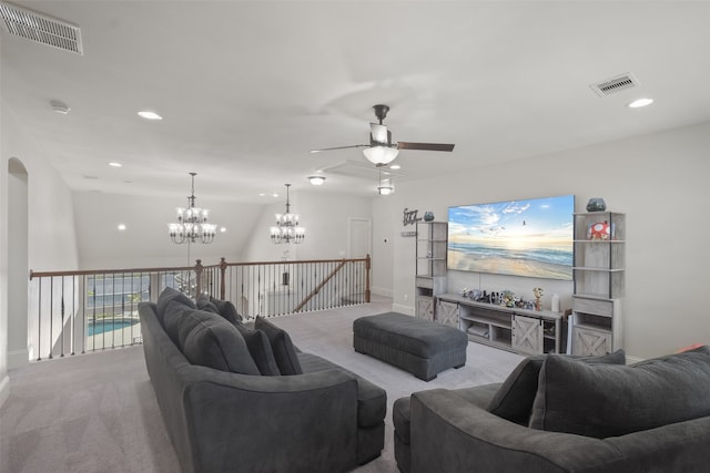 living room featuring light colored carpet and ceiling fan with notable chandelier