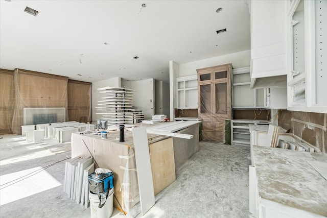 kitchen with a large island and white cabinetry