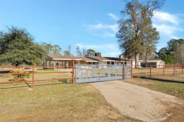 view of gate featuring a yard