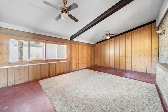 bonus room featuring ceiling fan, lofted ceiling with beams, carpet floors, and wood walls