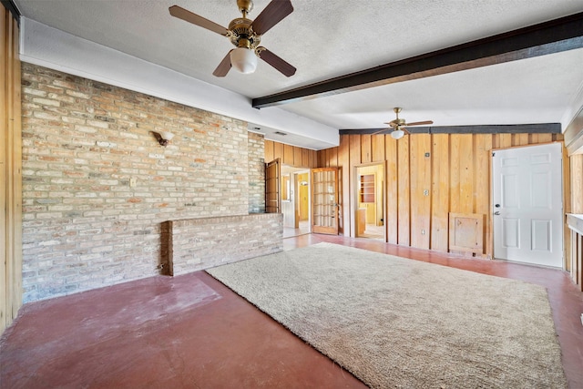 unfurnished living room with brick wall, vaulted ceiling with beams, and a textured ceiling