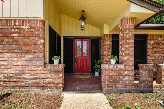 view of exterior entry with a porch