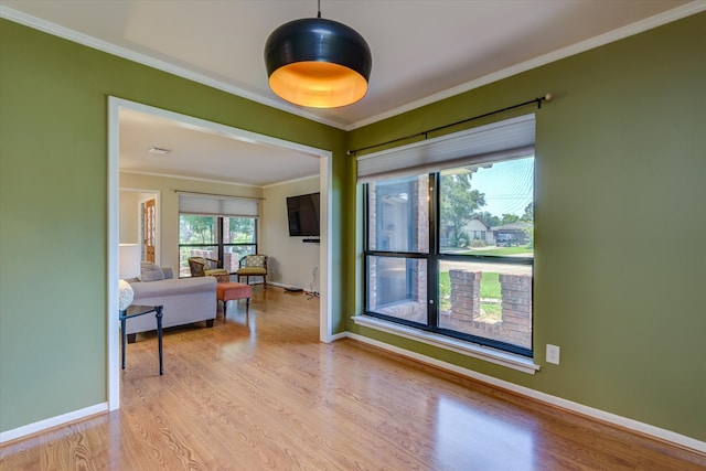 interior space with crown molding and light wood-type flooring