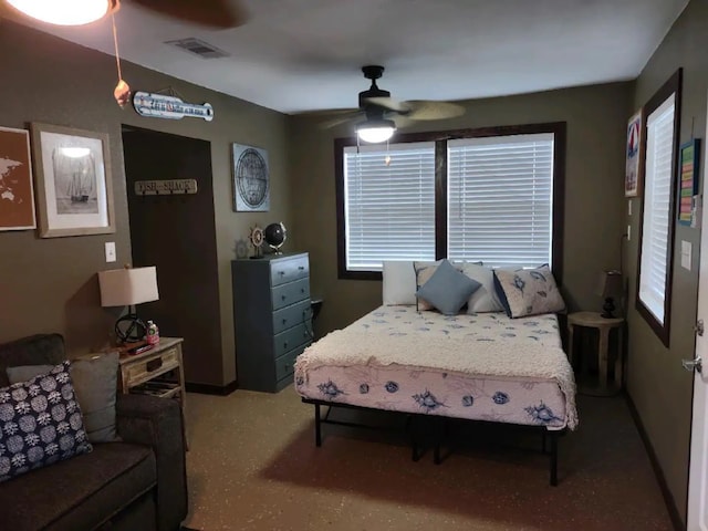 bedroom featuring multiple windows and ceiling fan