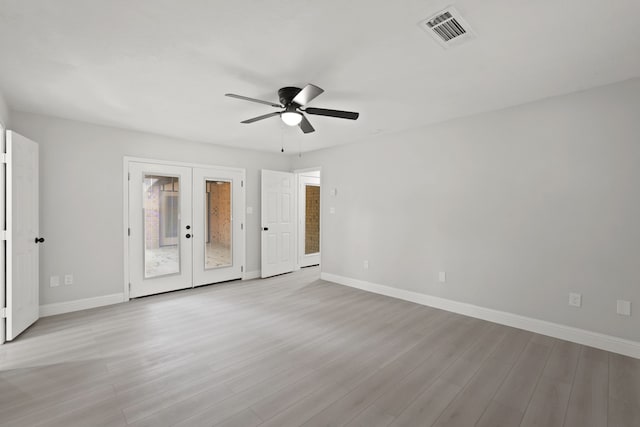 empty room featuring light hardwood / wood-style flooring, french doors, and ceiling fan