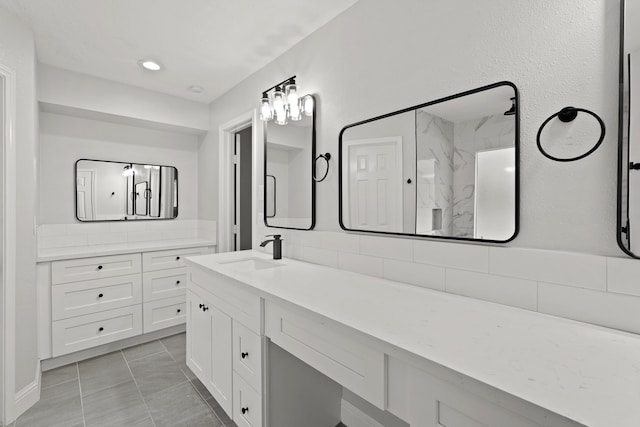 bathroom with vanity, walk in shower, and tile patterned flooring