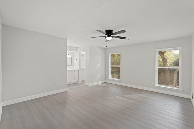 unfurnished room with light hardwood / wood-style floors, a healthy amount of sunlight, and ceiling fan