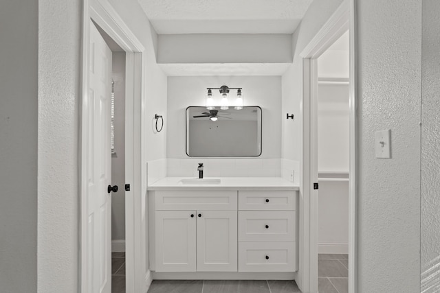 bathroom featuring vanity, ceiling fan, tile patterned floors, and a textured ceiling