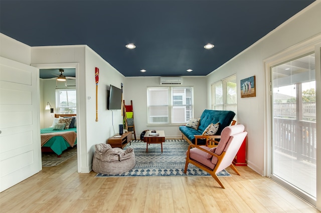 sitting room with wood-type flooring and a healthy amount of sunlight