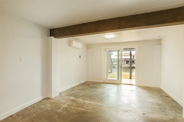 spare room featuring a wall unit AC and beam ceiling