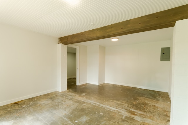 spare room featuring electric panel, concrete flooring, and beam ceiling