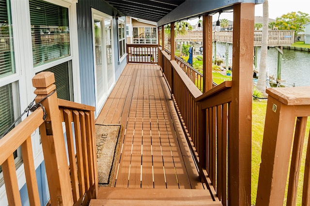 wooden terrace featuring a water view