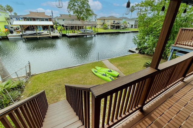 exterior space featuring a water view, a lawn, and a dock