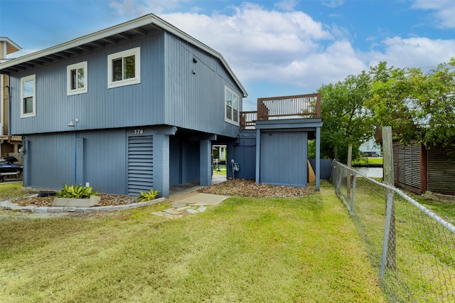 back of property featuring a storage unit and a yard