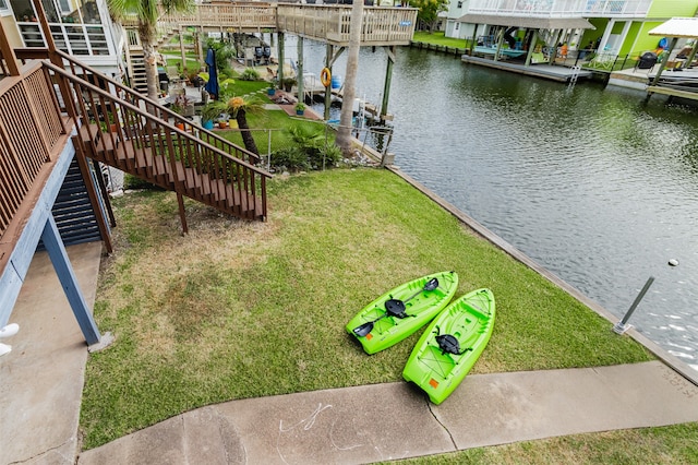 exterior space with a water view, a yard, and a boat dock