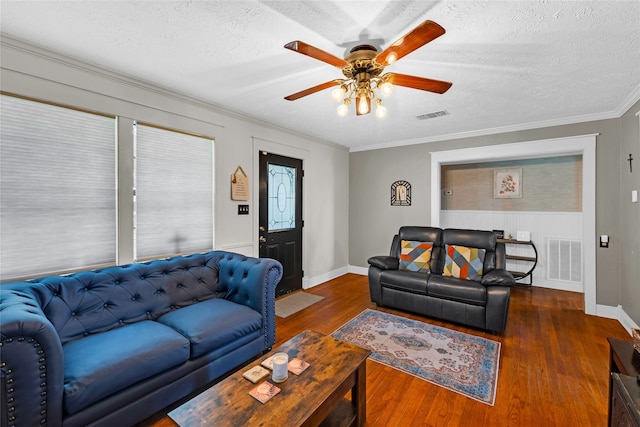 living room featuring ceiling fan, crown molding, a textured ceiling, and dark hardwood / wood-style flooring