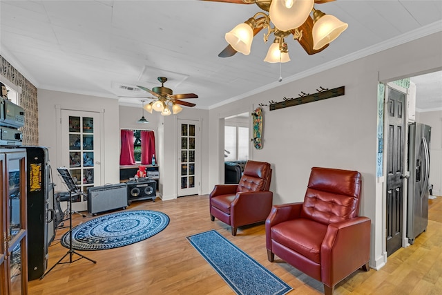 sitting room featuring ornamental molding, hardwood / wood-style flooring, and ceiling fan