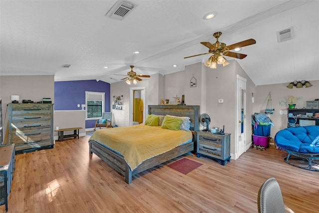 bedroom with light hardwood / wood-style floors, vaulted ceiling, and ceiling fan