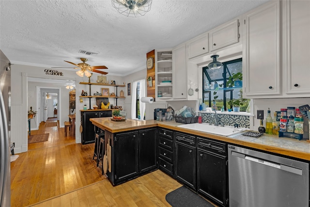 kitchen featuring light hardwood / wood-style flooring, sink, crown molding, white cabinets, and appliances with stainless steel finishes