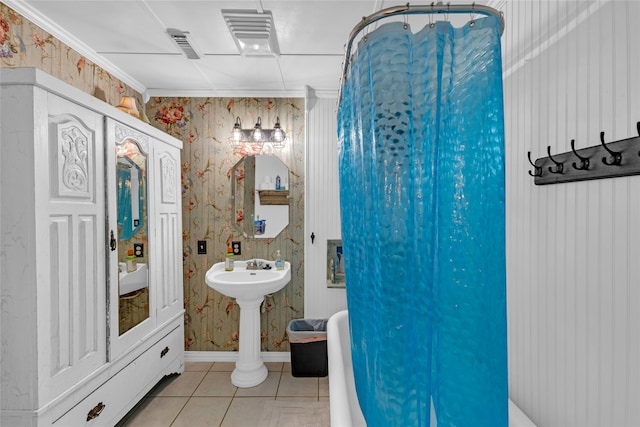 bathroom with a bathtub, tile patterned floors, and sink